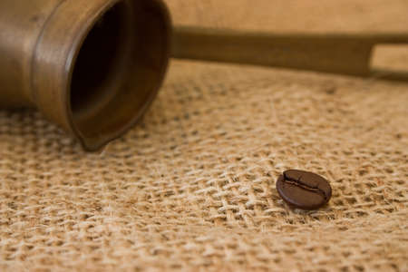 Coffee pot and coffee bean on burlap sack backgroundの写真素材