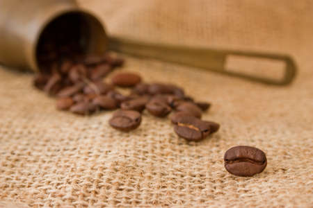 Coffee pot and coffee beans on burlap sack backgroundの写真素材
