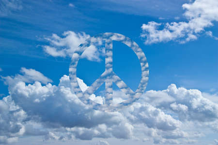 Blue sky with symbol of peace in the cloudsの写真素材