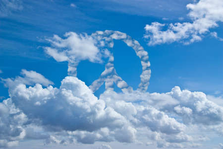 Blue sky with symbol of peace in the clouds