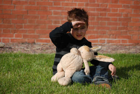 Little boy with a toy hare in hands