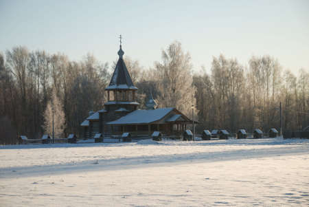 Old russian wooden village with church, building and wellの写真素材