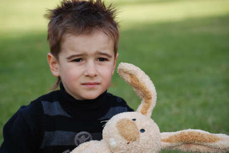 Little boy with a toy hare in hands