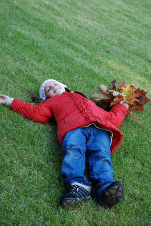 little girl in an autumn parkの写真素材