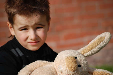 Little boy with a toy hare in handsの写真素材