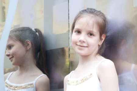 portrait of little girl next to a mirrorの写真素材