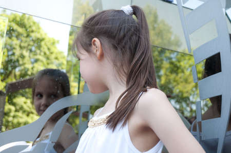 portrait of little girl next to a mirrorの写真素材