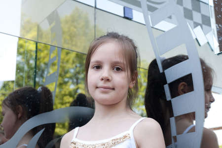 portrait of little girl next to a mirrorの写真素材