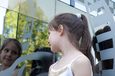 portrait of little girl next to a mirrorの写真素材