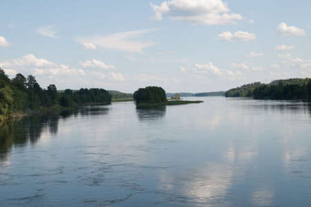 water smooth surface with the reflection of cloudsの写真素材