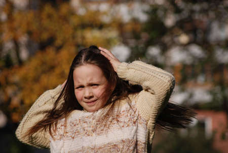 girl with blown  about from wind hairsの写真素材