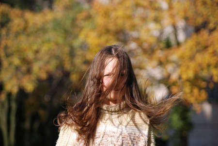 girl with blown  about from wind hairsの写真素材