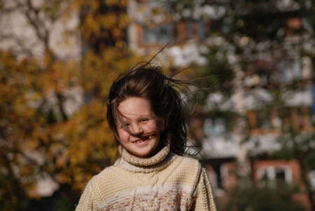 girl with blown  about from wind hairsの写真素材