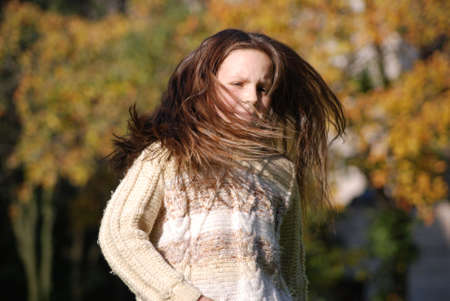 girl with blown  about from wind hairsの写真素材