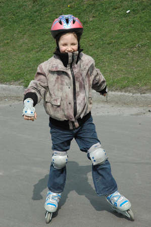 Young girl rollerblading, in a protective clothing