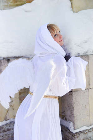 Blonde girl with long hair and angel's wingsの写真素材