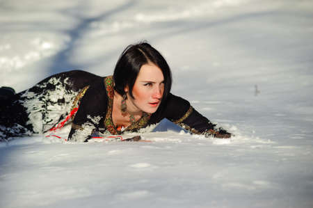 Picture of a girl who lies on the snowの写真素材