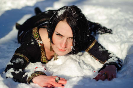 Picture of a girl who lies on the snowの写真素材