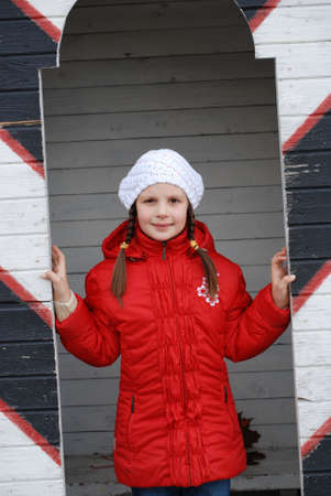 The girl in a red jacket near to a sentry boxの写真素材