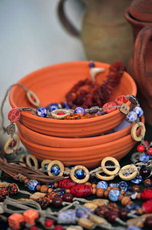 Clay bowls and bright ceramic beads of handworkの写真素材
