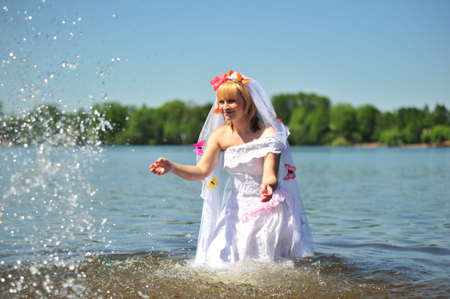 portrait of bride dressed in wedding gown in waterの写真素材