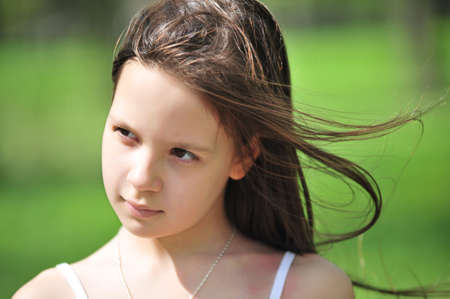 Portrait of the little girl with long hair looking asideの写真素材