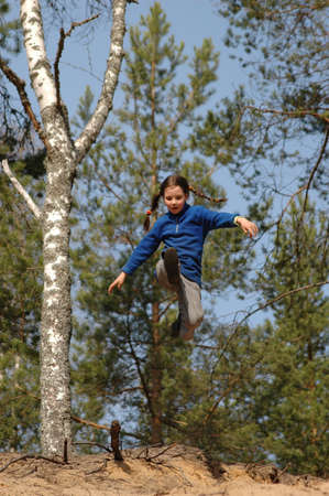 girl, jumping from a sandy slope