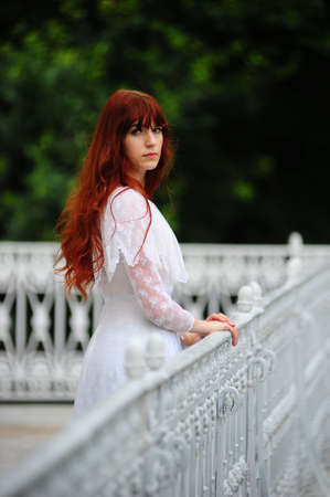 The girl on a balcony at a handrailの写真素材