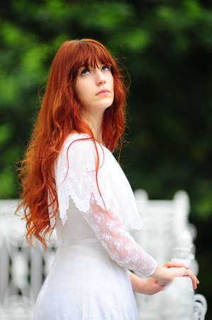 The girl on a balcony at a handrailの写真素材