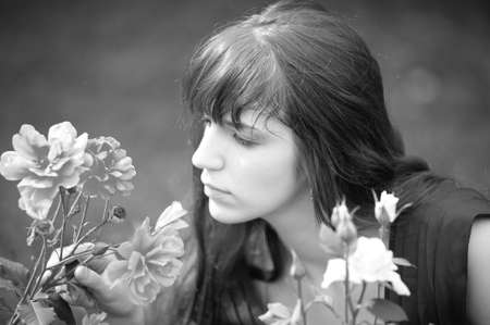 The red-haired girl near to roses
