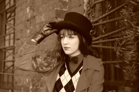 Beautiful young woman wearing a black cylinder hatの写真素材