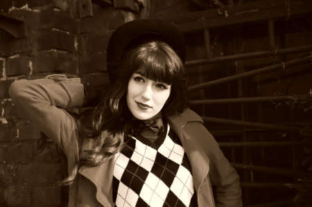 Beautiful young woman wearing a black cylinder hatの写真素材