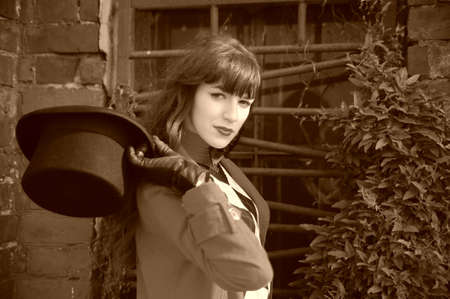 Beautiful young woman wearing a black cylinder hatの写真素材