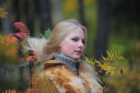 beautiful young woman in autumn parkの写真素材