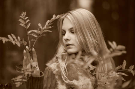beautiful young woman in autumn parkの写真素材