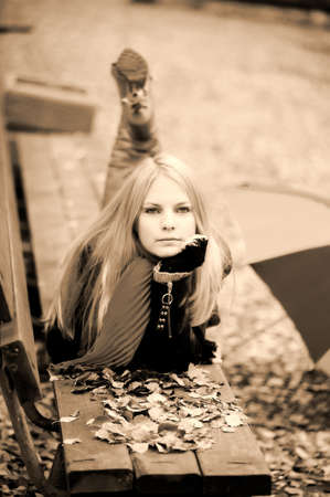 girl lying on a benchの写真素材