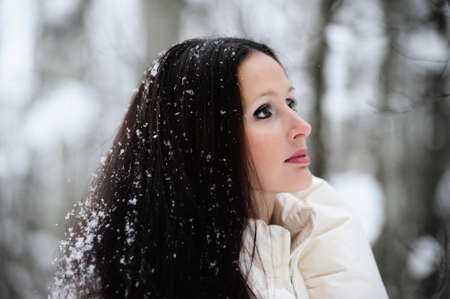 Brunette with snowflakes on her hairの写真素材