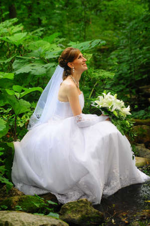 a bride sitting by the streamの写真素材