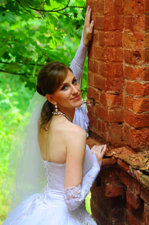 Bride sitting on ruinsの写真素材