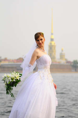 happy bride with a bouquet of white liliesの写真素材