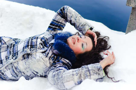 woman lying in the snowの写真素材