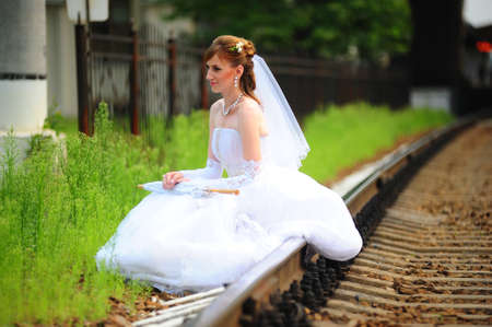 The bride sitting on railsの写真素材