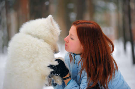 Girl with a puppy Samoyed 