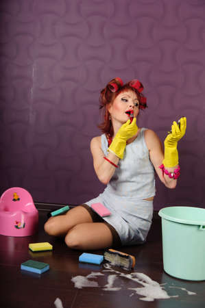 Sexy housewife is cleaning the floorの写真素材