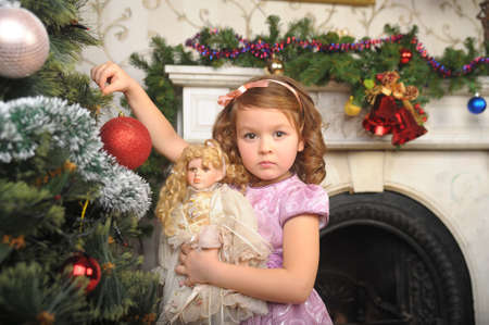 little girl with a doll in  hands. Photos in retro styleの写真素材