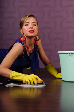 Sexy housewife is cleaning the floorの写真素材