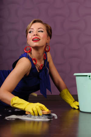 Sexy housewife is cleaning the floorの写真素材