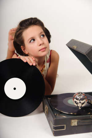 Girl with a gramophone and recordsの写真素材