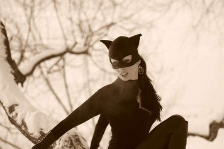 Beautiful young woman wearing  catsuit and maskの写真素材
