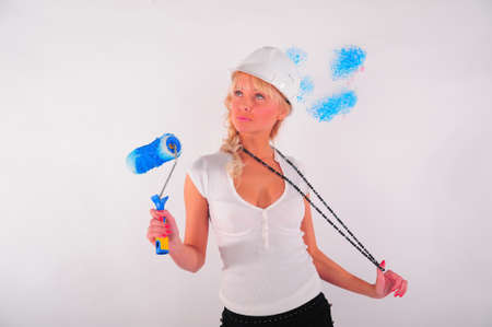 Rear view of a woman painting the wallの写真素材